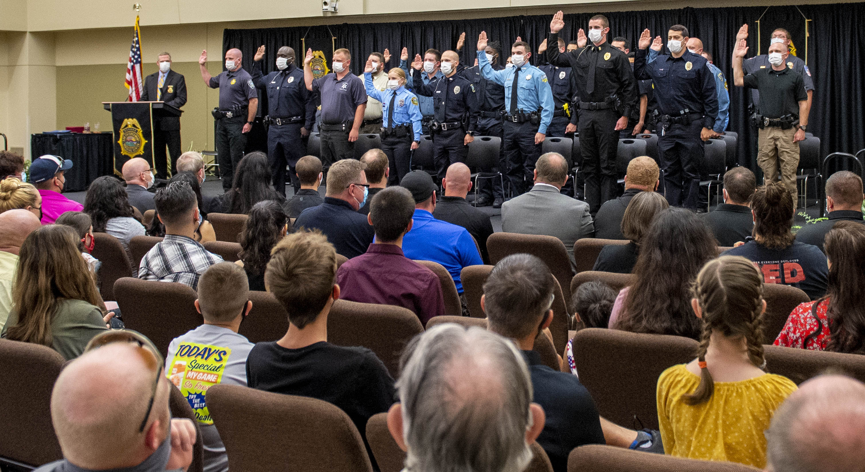 The 282nd Basic Training Class recites the Law Enforcement Oath of Office in front of the attending audience