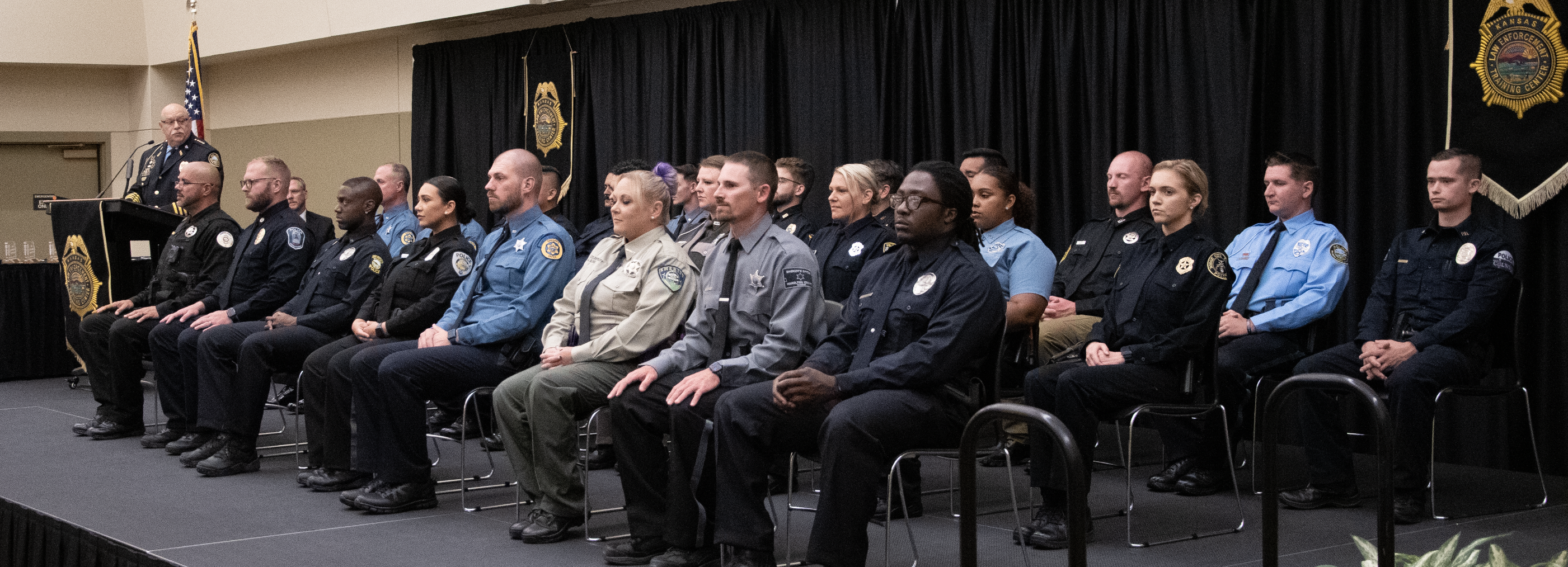 Captain Guy Schroeder of the Wichita University Police Department addresses the 294th graduating class