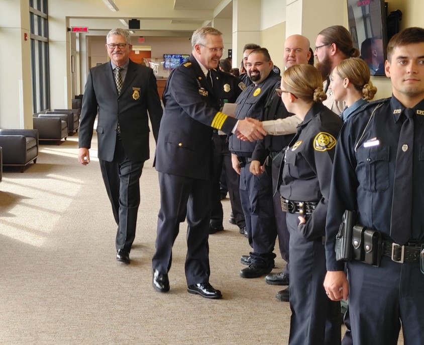 Interim Chief Livingston shakes hands with 301 graduates