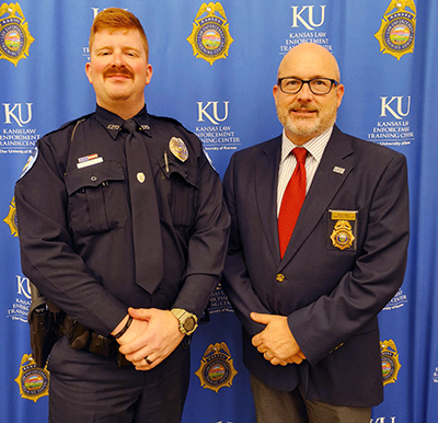 KLETC Executive Director Darin Beck stands with the 285th class president Officer Grady Carl