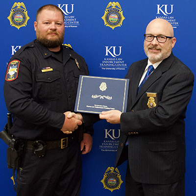"KLETC Executive Director Darin Beck stands with the class president of the 294th basic training class, Officer Dustin Hiebsch of the Pittsburg Police Department "
