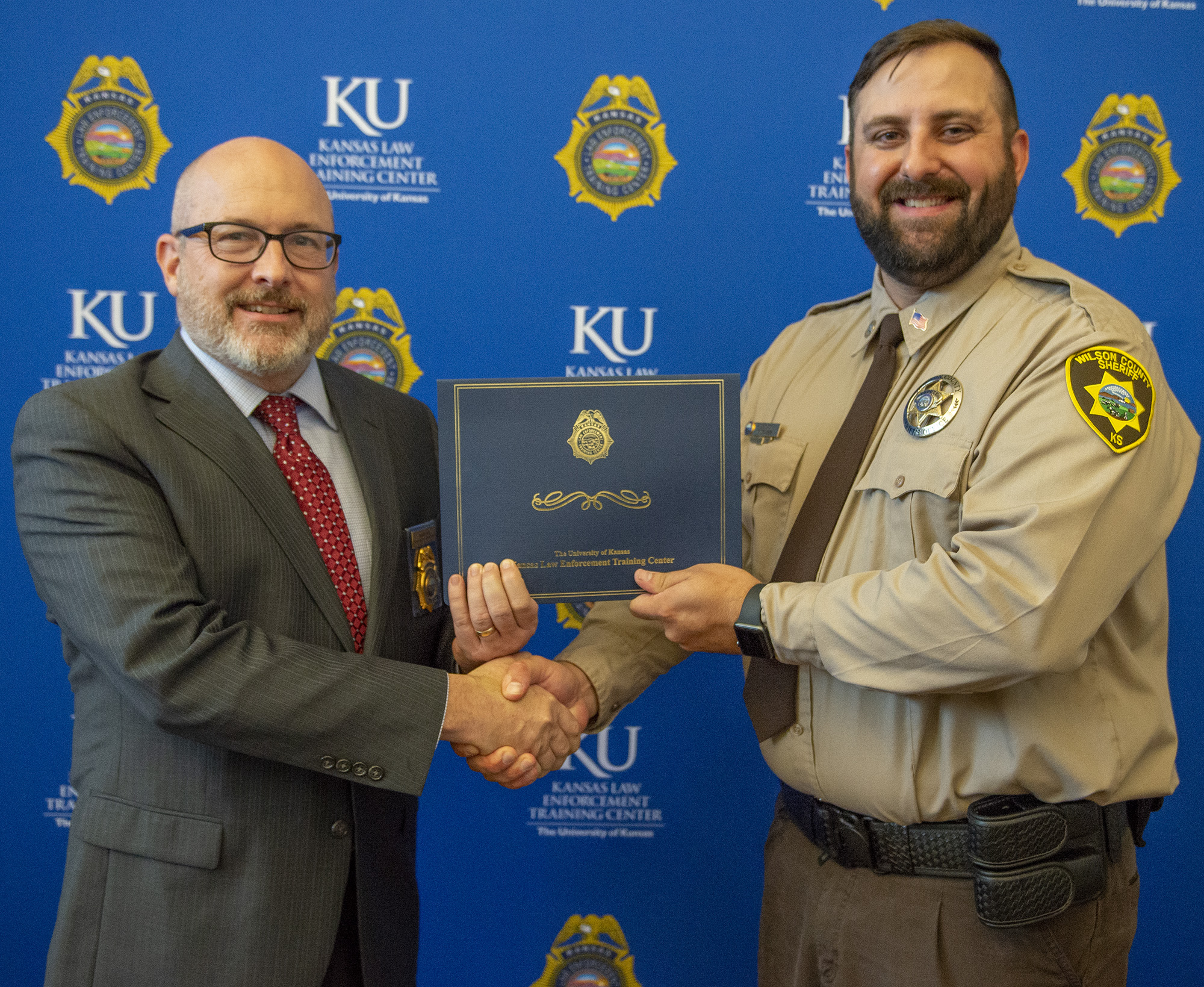 "KLETC Executive Director Darin Beck stands with the class president of the 298th, Deputy David Decker"