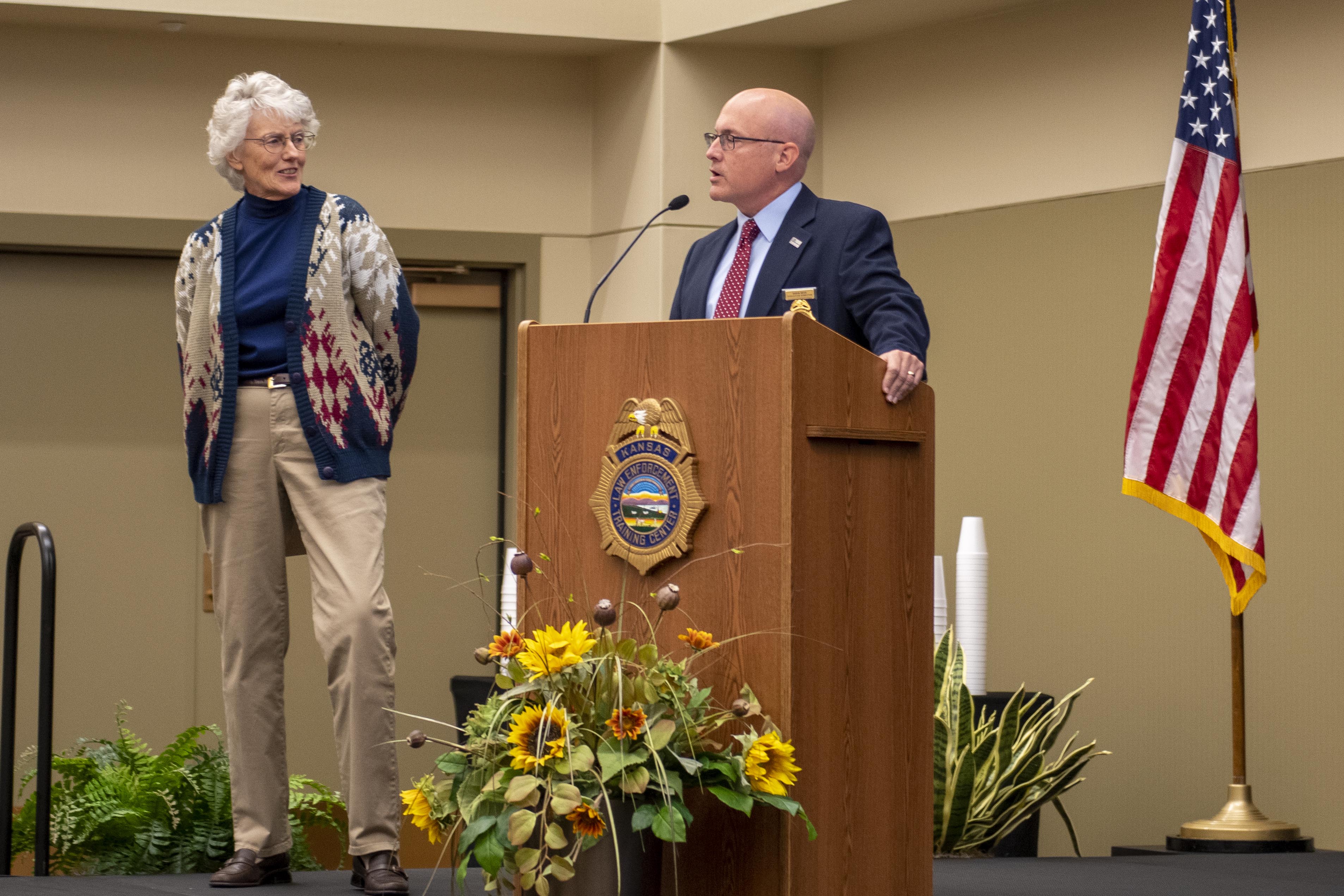 KLETC Executive Director Darin Beck delivers remarks at Beckie Miller's retirement celebration before presenting her a letter from KU Provost Carl Lejuez and Chancellor Douglas A. Girod granting her Emeritus status.