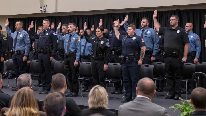 The 281st Basic Training Class recites the Law Enforcement Oath of Office in front of the attending audience.